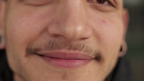 Close-up-shot-of-smiling-young-man-with-thin-moustaches